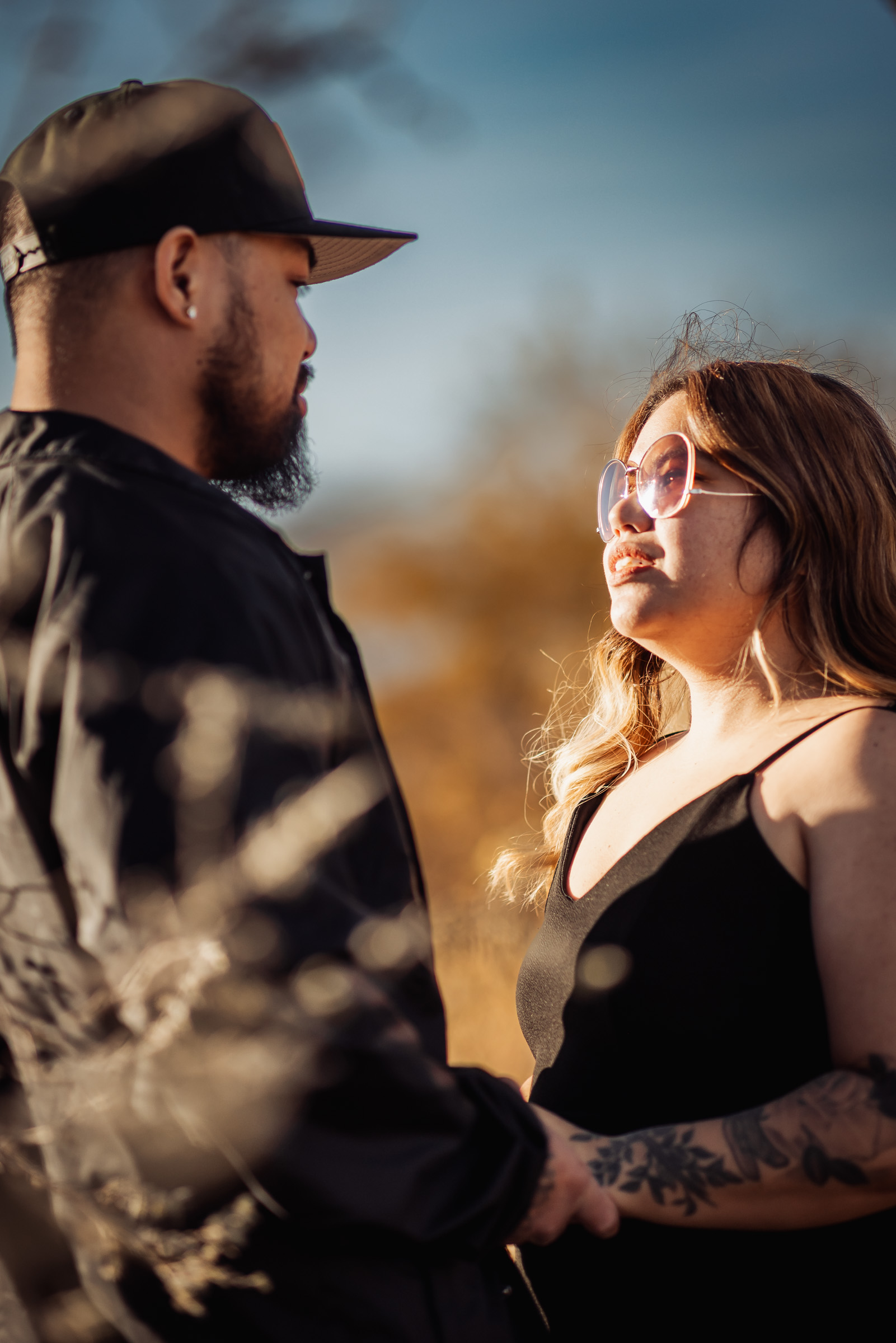 Couple laughing together in warm afternoon light during a Summerlin couples session
