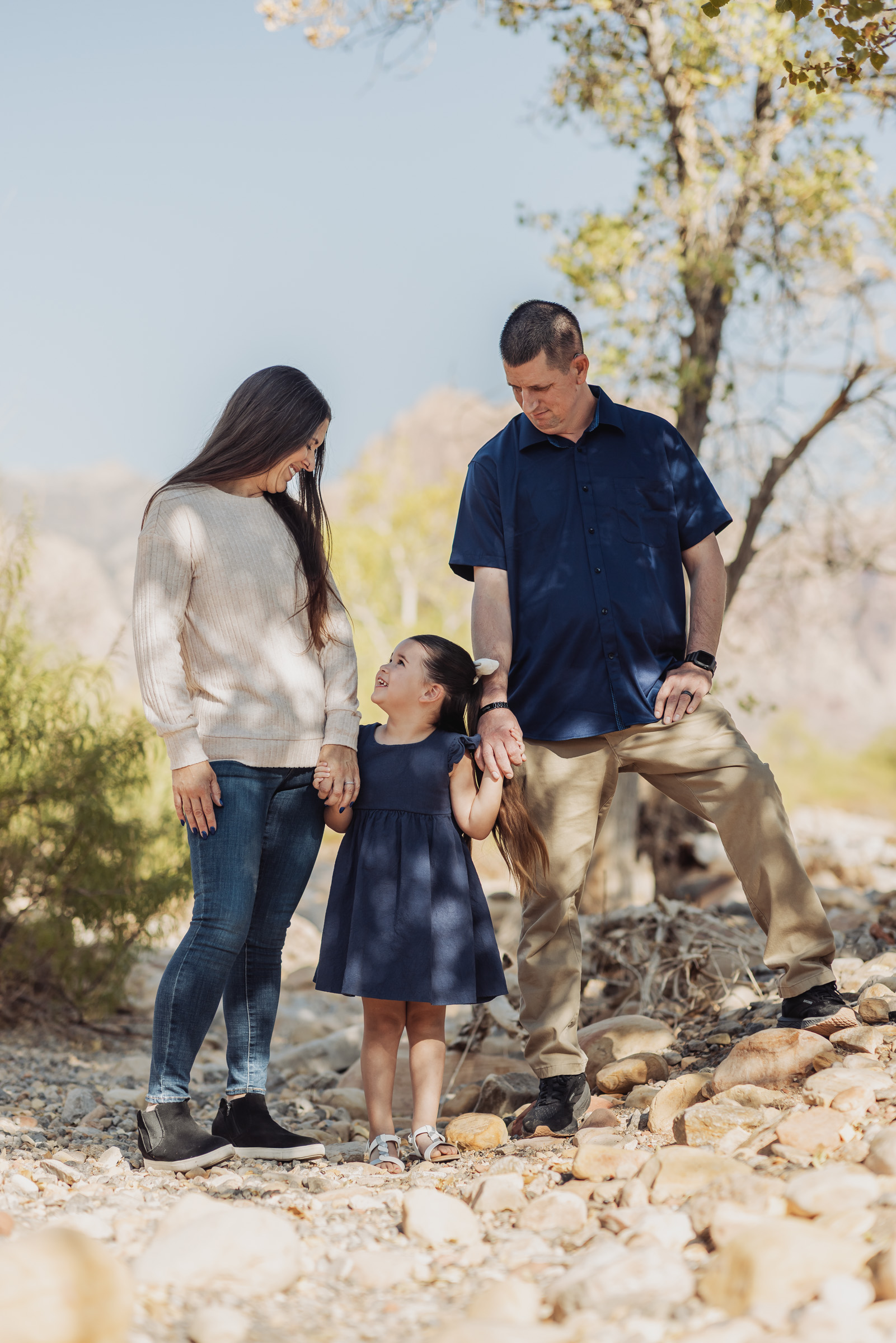 Family photographed beside a sandstone boulder in Calico Basin near Red Rock Canyon