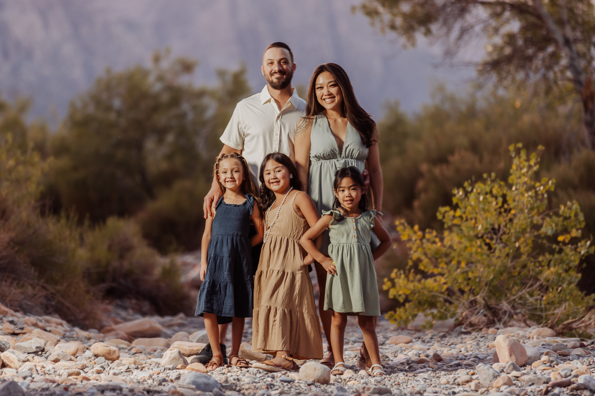 Family of six walking through desert brush at Red Rock Canyon