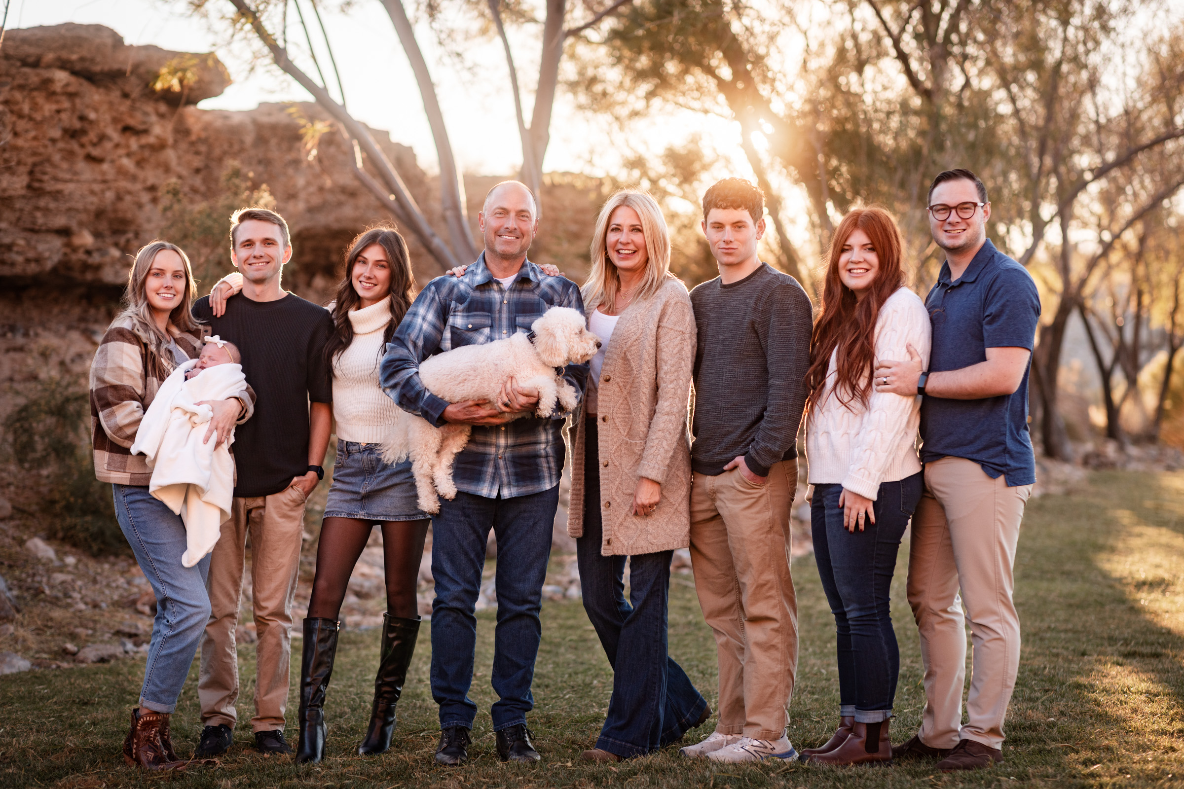 Extended family standing together on a Summerlin trail at sunset in Las Vegas