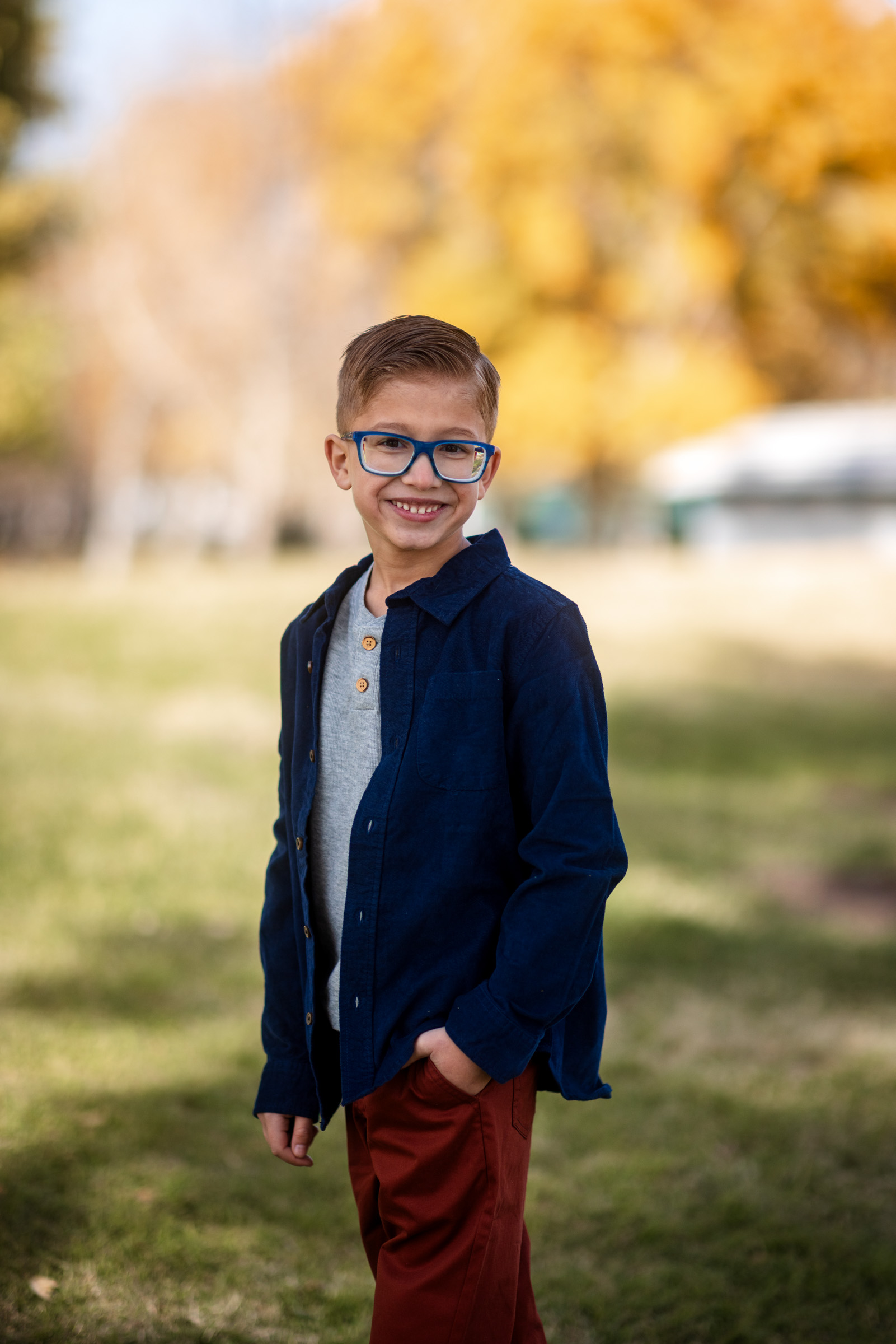 Young boy in a blazer photographed on a park path during a Centennial Hills kids session