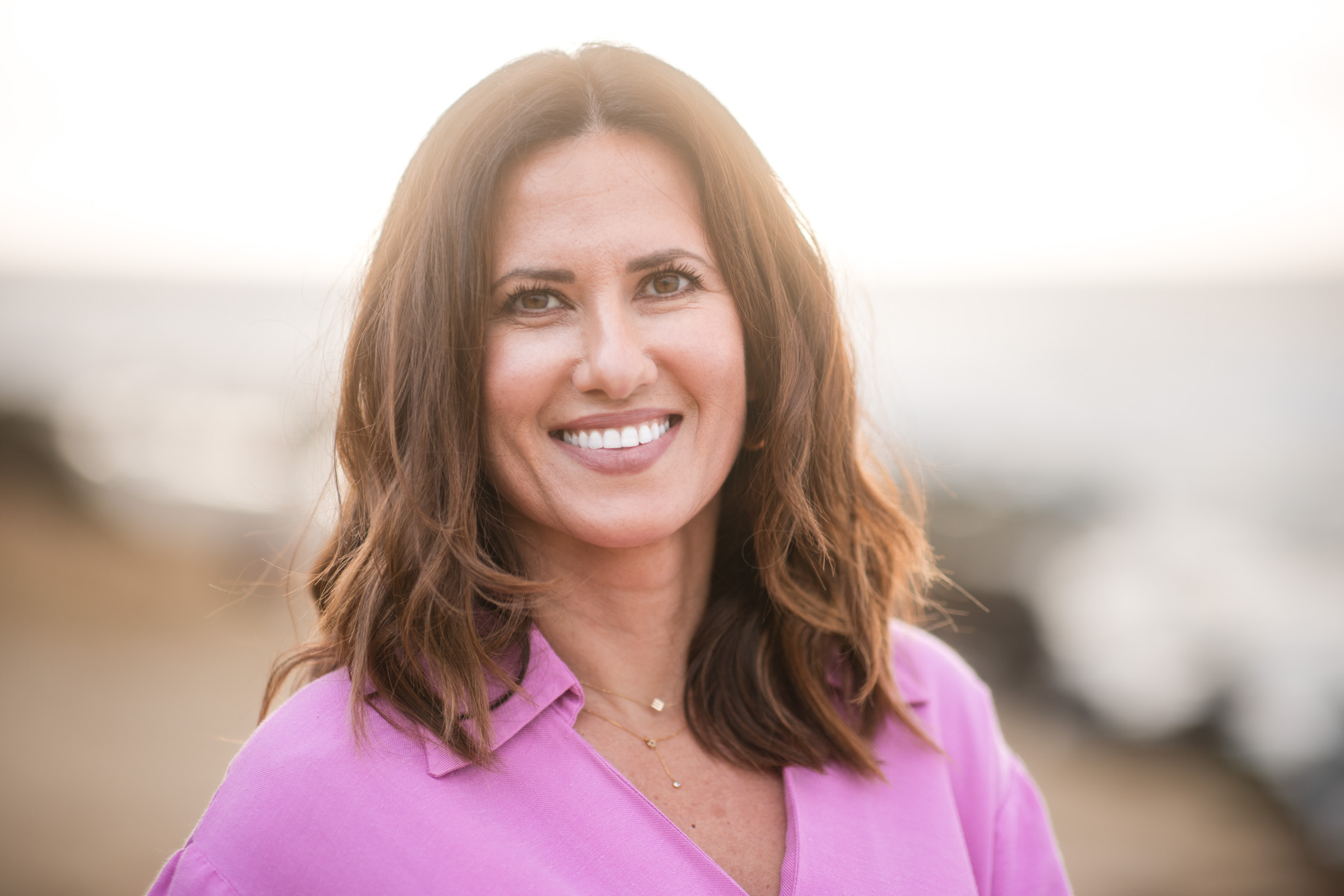 Professional headshot photographed in soft, warm natural light