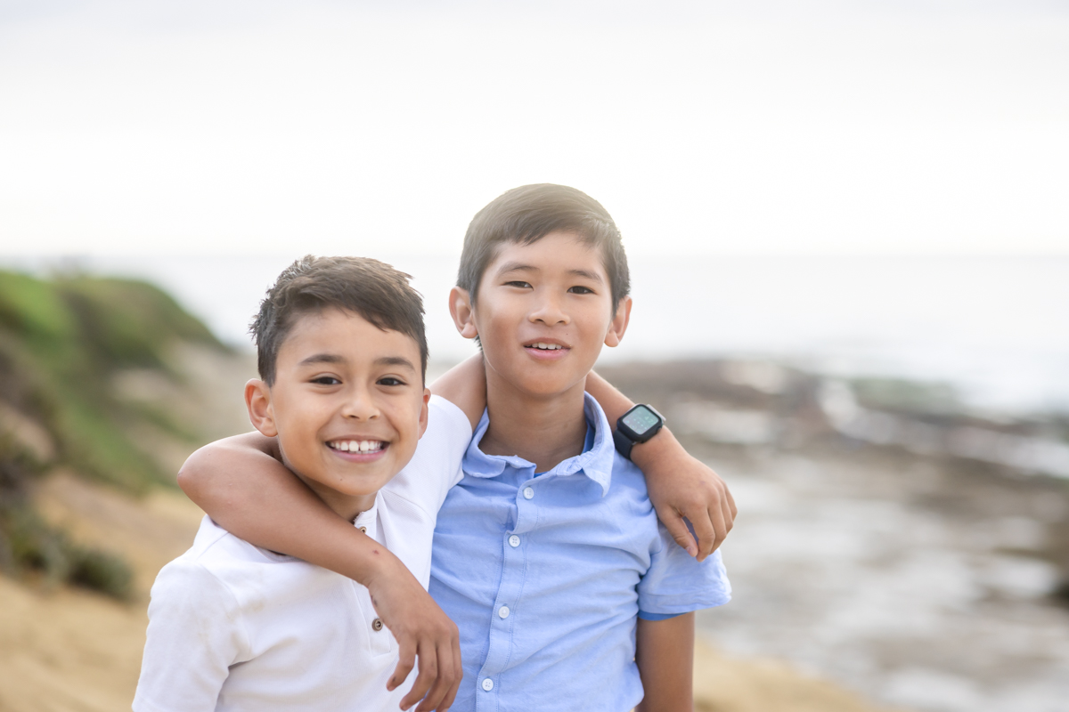 Two brothers smiling together during a Las Vegas sibling portrait session