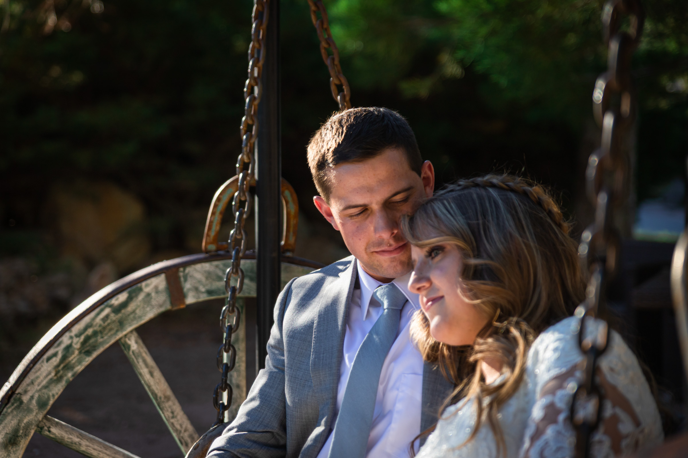 Couple on a wooden swing during a mountain session at Mount Charleston near Las Vegas