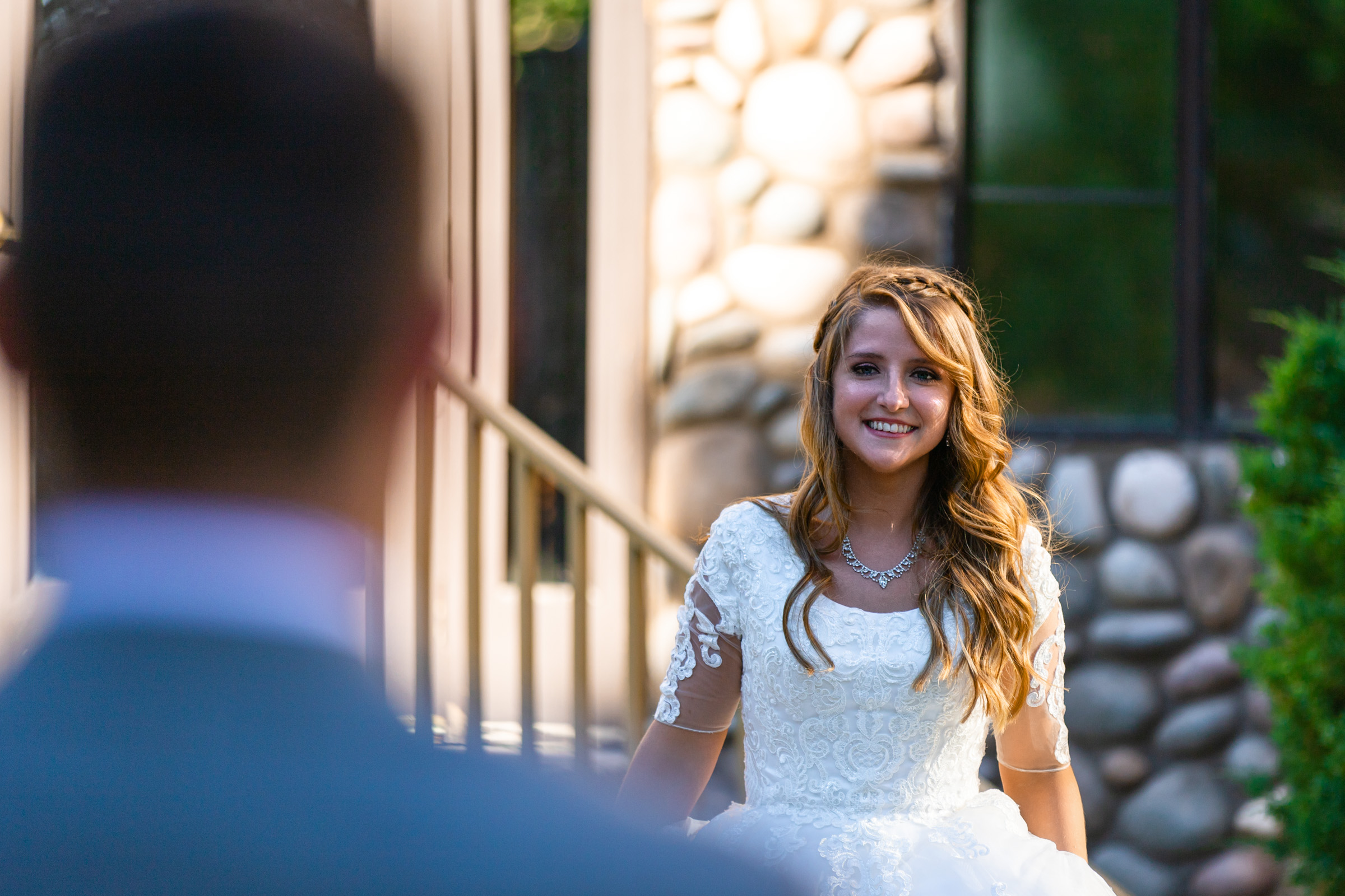 A bride smiling as she sees her groom for the first time at Mount Charleston