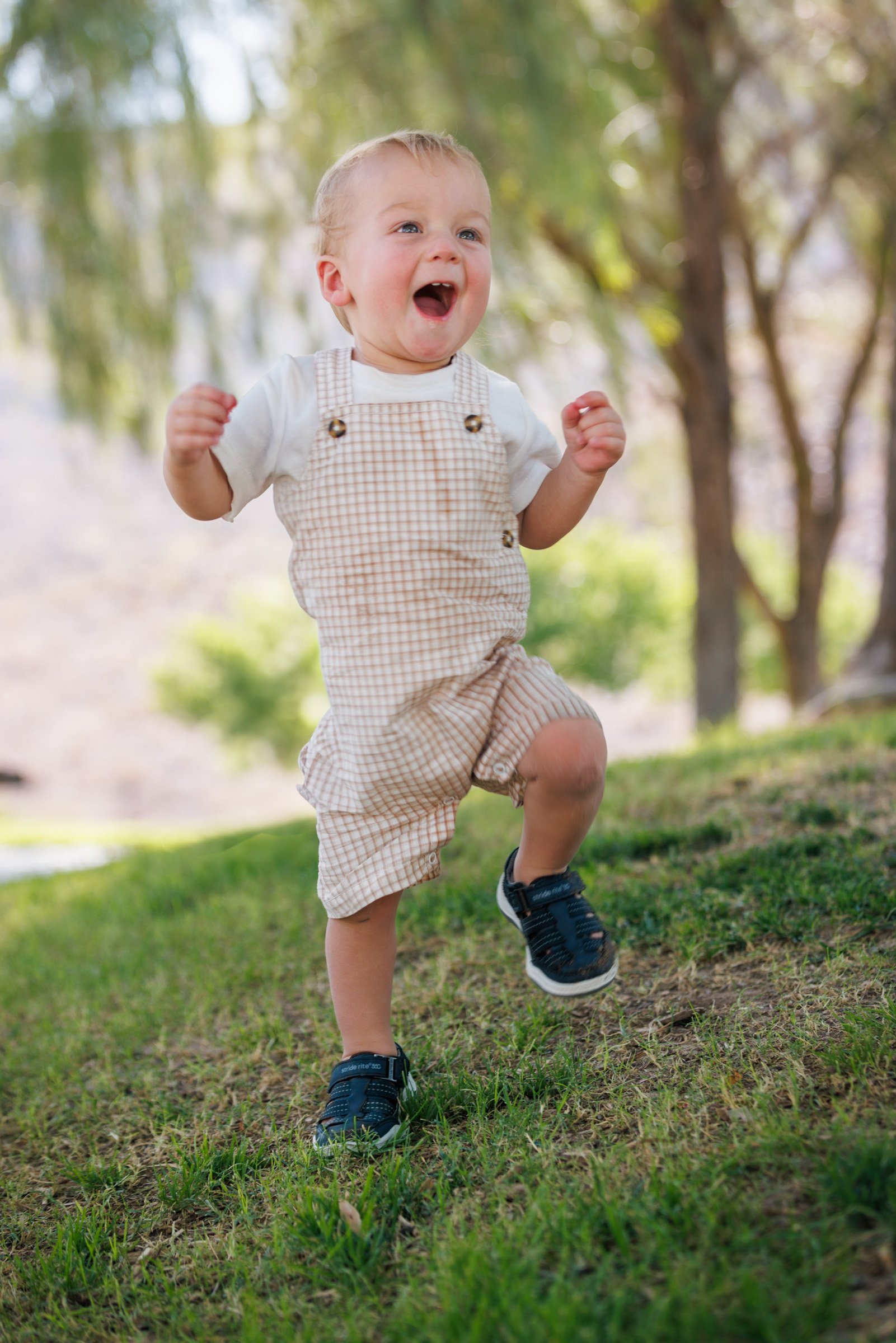 Toddler running across the grass during a Henderson kids photo session