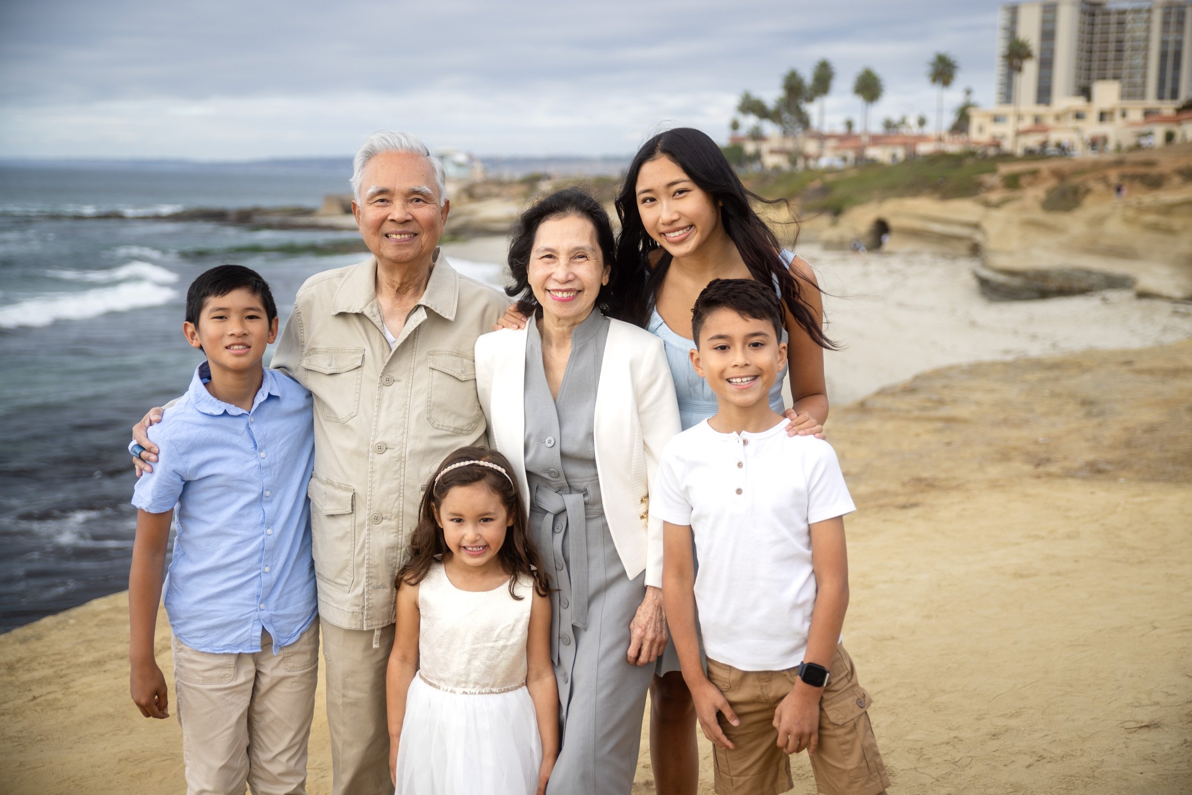 Large extended family photographed on the lawn above La Jolla Cove in San Diego