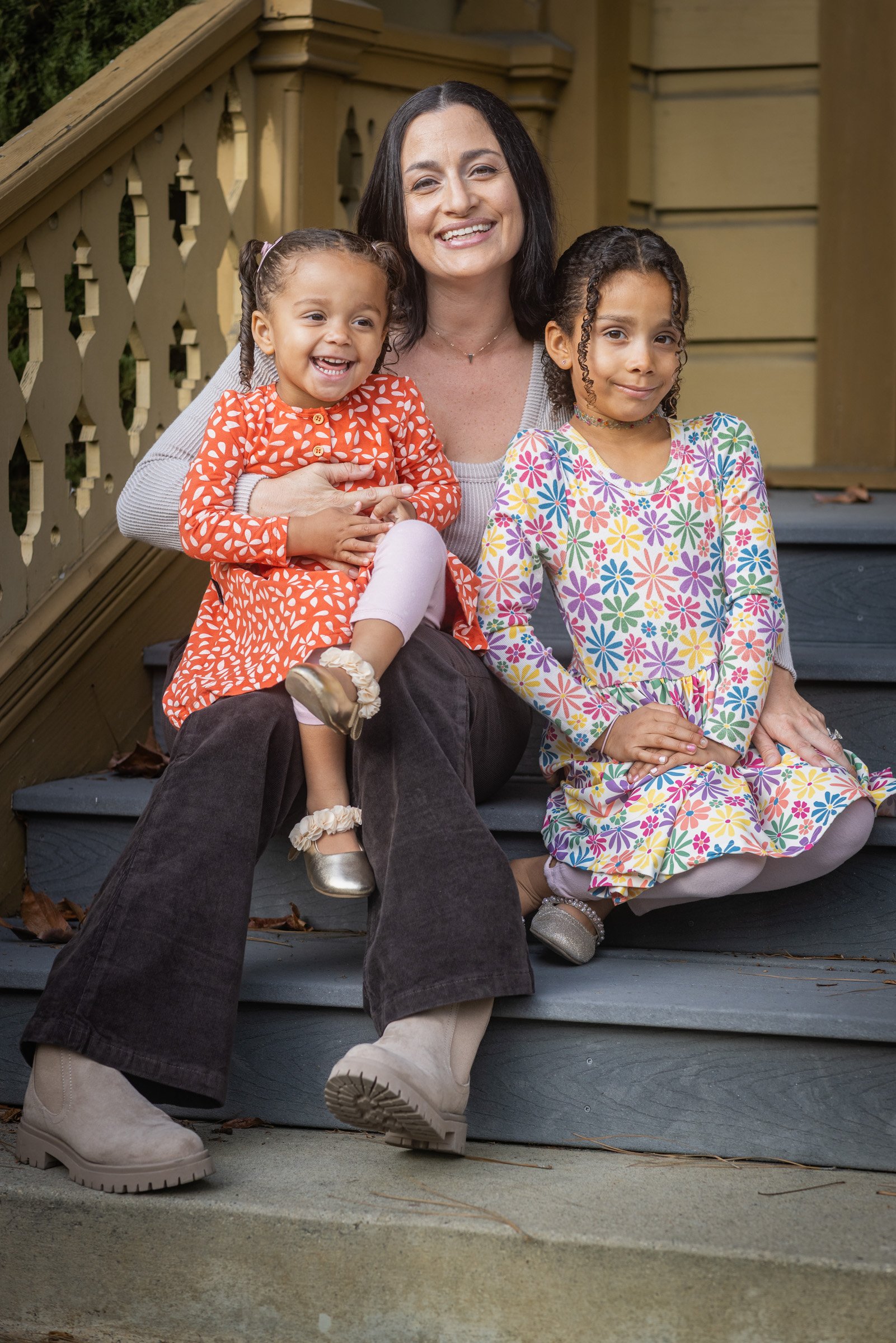 Mother and two daughters seated on a Victorian porch in Old Town San Diego