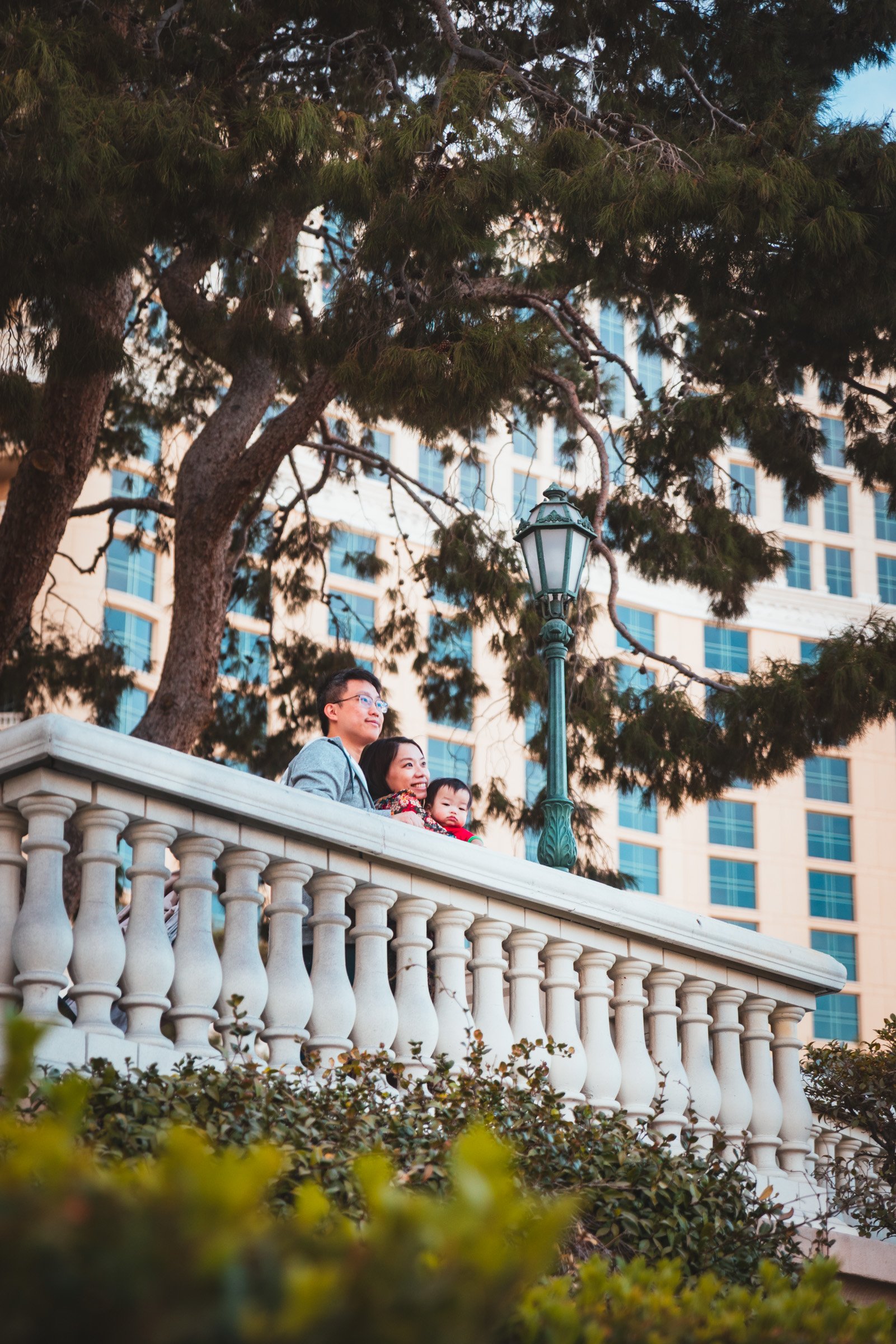 Family photographed on a resort balustrade with a Las Vegas Strip tower behind them