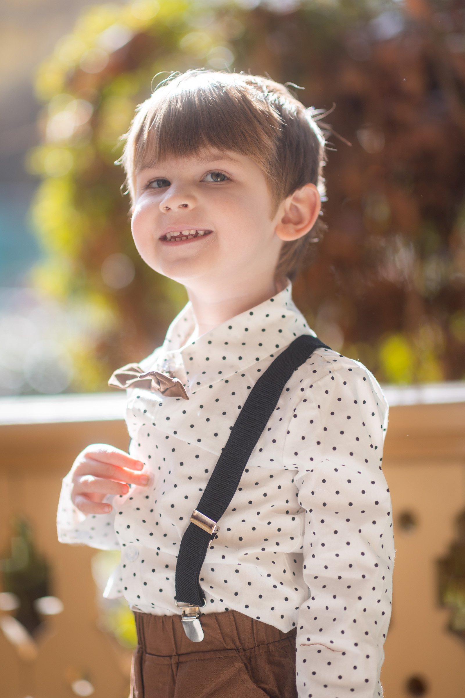 Young boy in suspenders photographed during an Old Town San Diego kids session