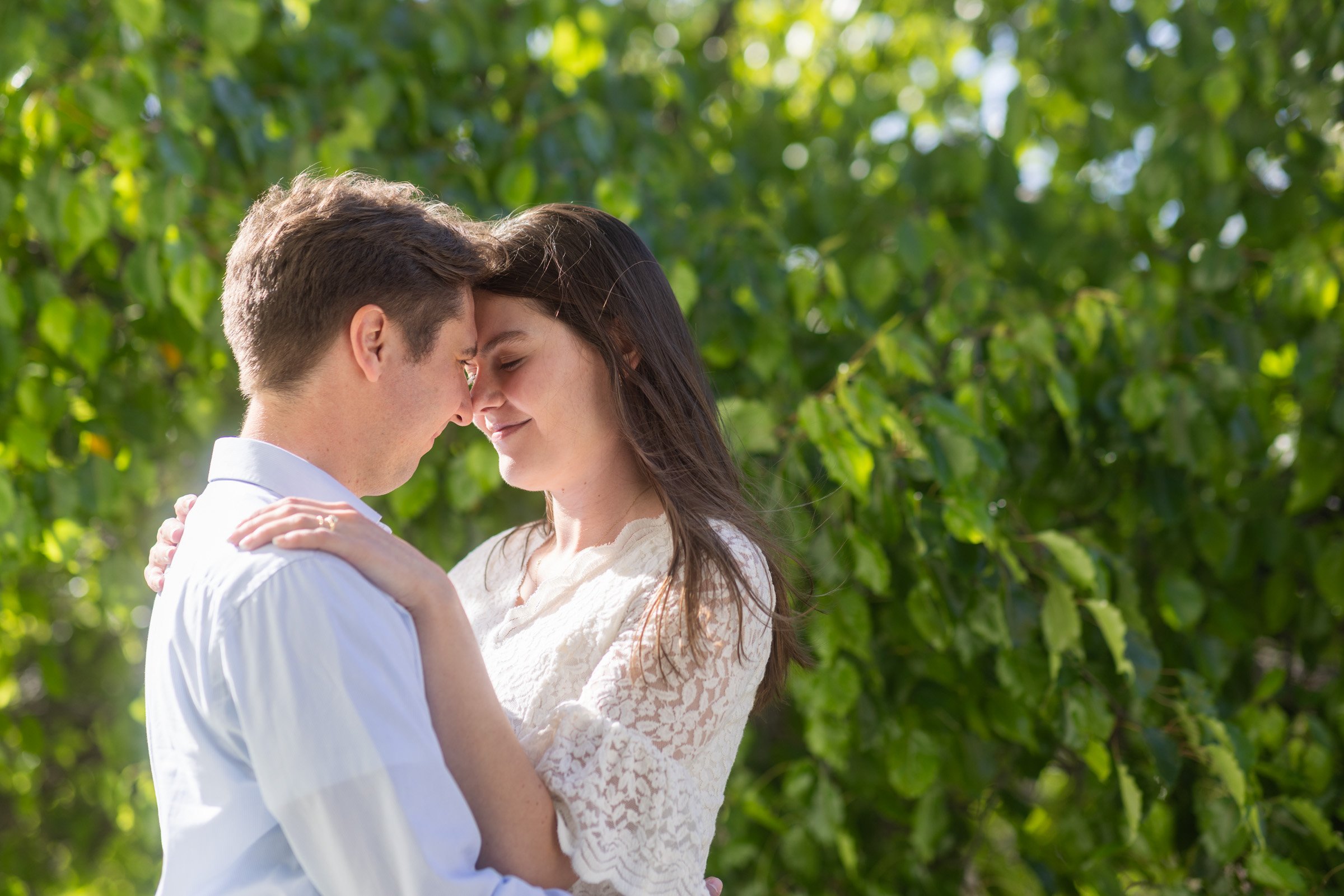 Couple photographed among the greenery of a courtyard in Old Town San Diego