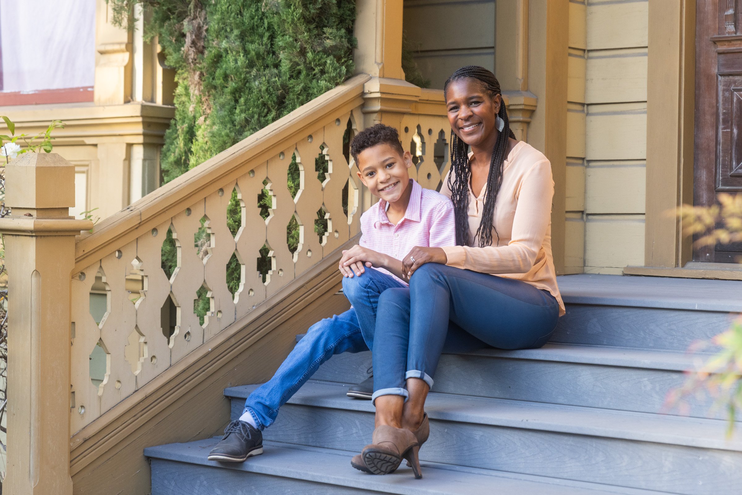 Mother and daughter seated on painted Victorian steps in Old Town San Diego